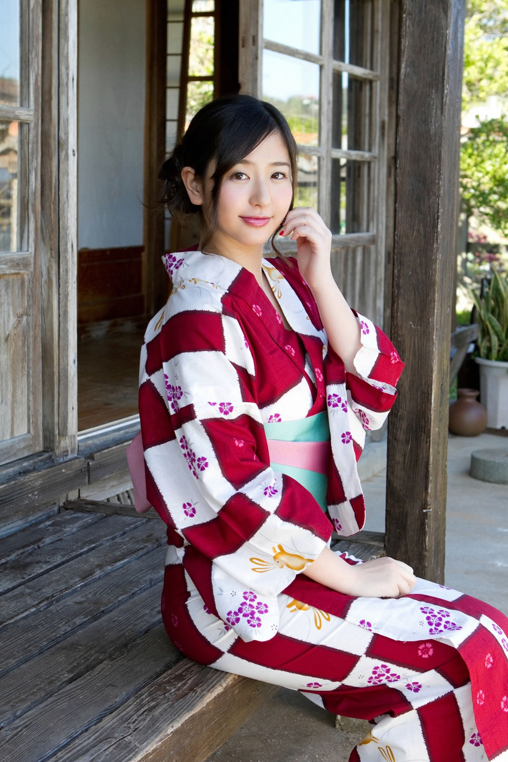 Model sitting with red and white Kimono