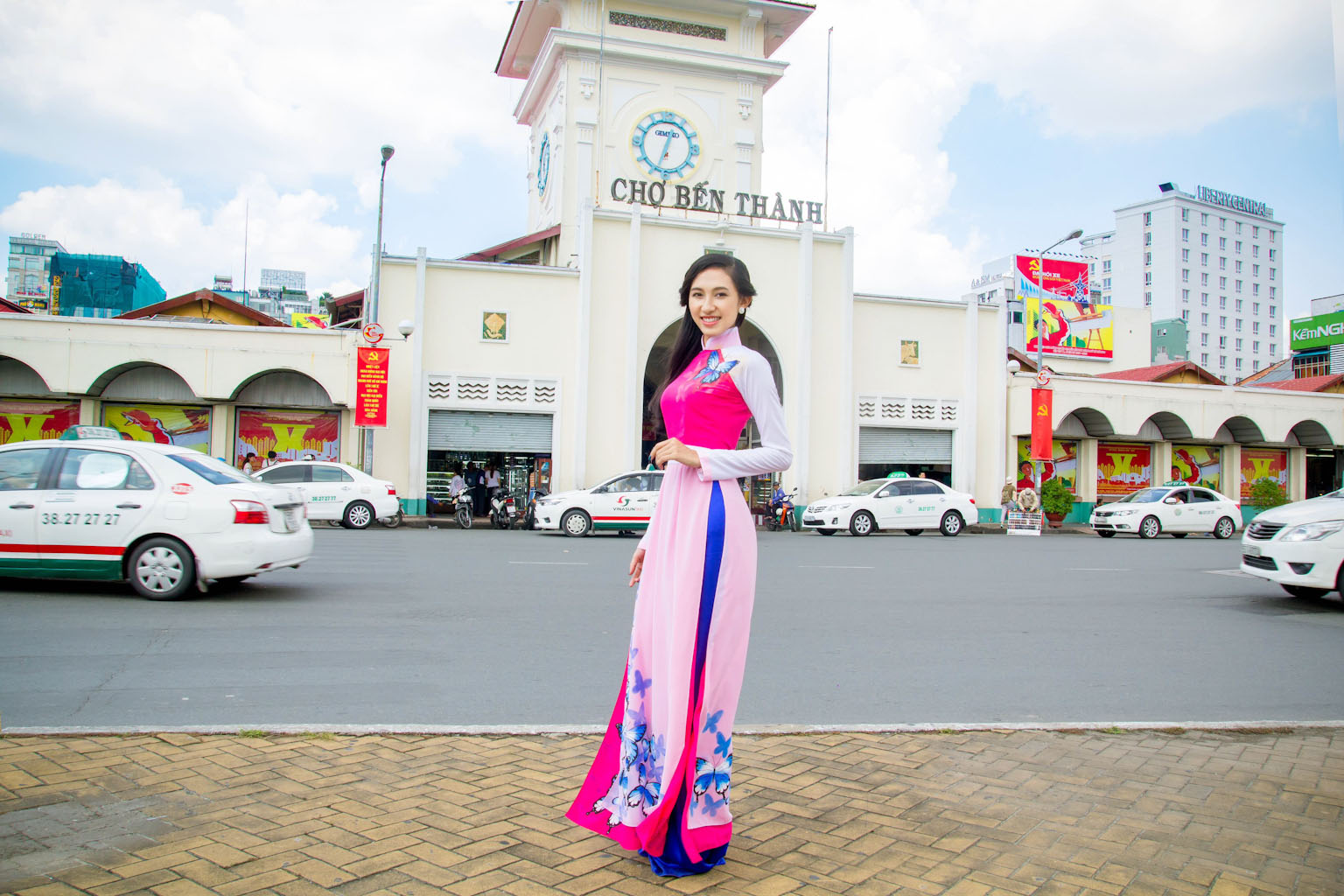 Model with purple and pink Ao dai on the street