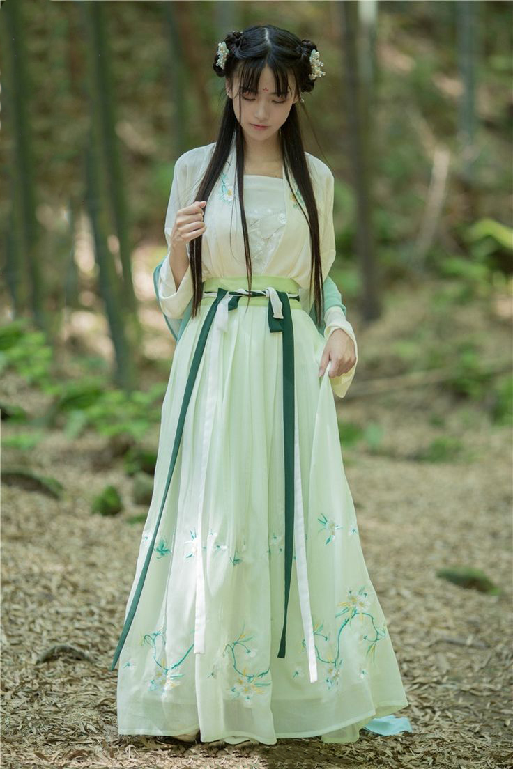 Model with green Hanfu and bamboo on the background