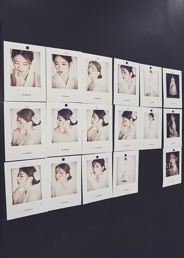 Multiple photos of the Hanbok model on wall